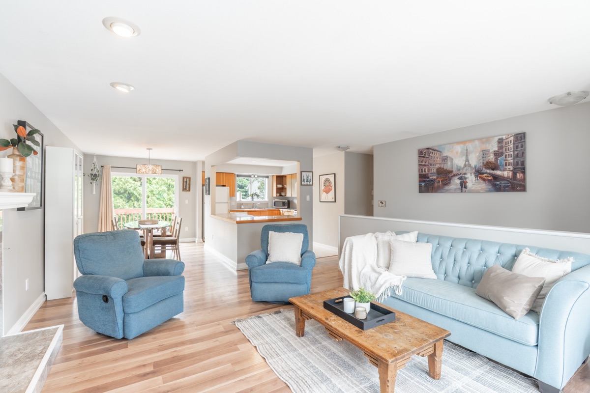 Open living room with blue armchairs and a light blue sofa