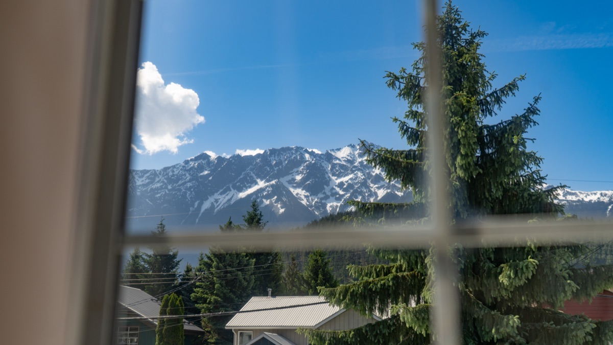 Snow-capped mountains seen through a window