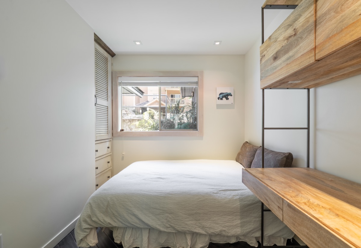 Bedroom with a built-in bunk loft and wood desk