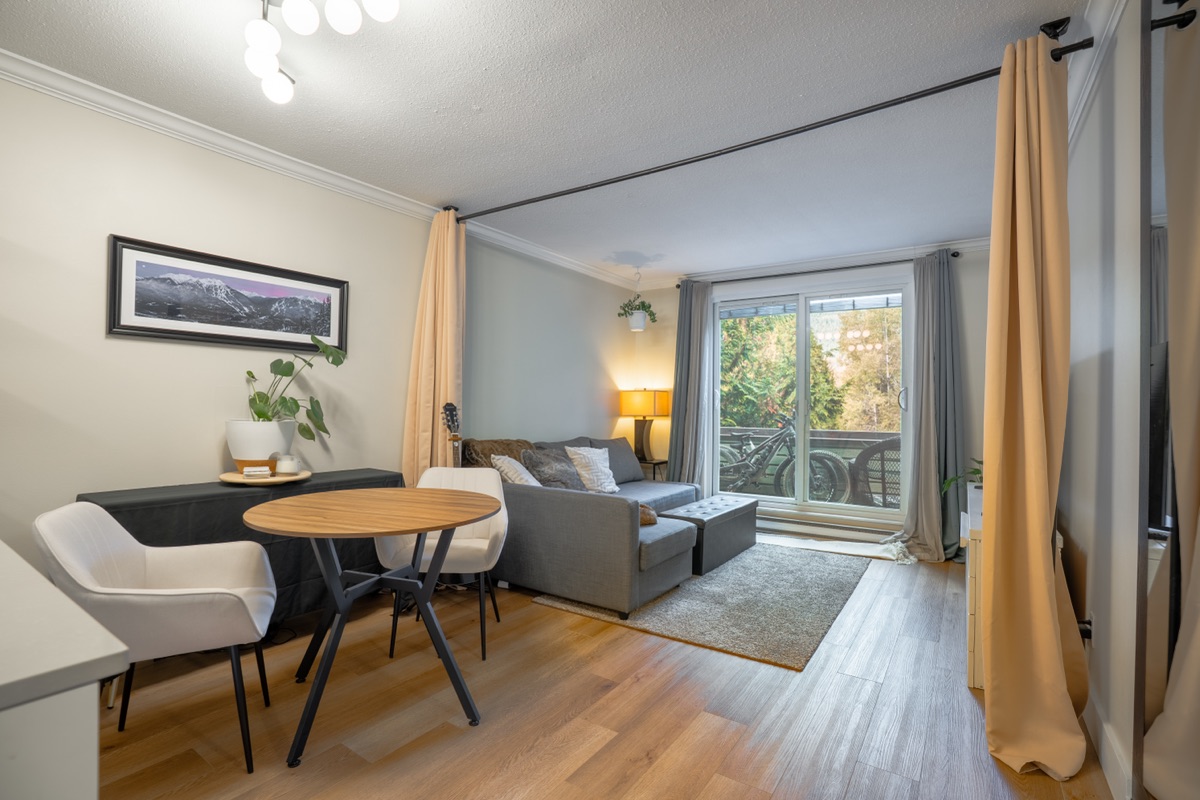 Living and dining area beside a balcony door